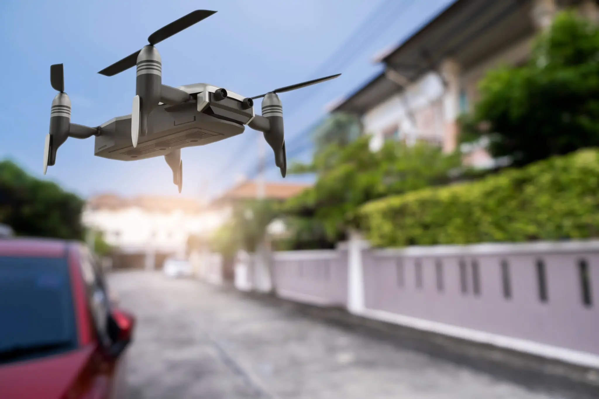 Quadcopter hovering near houses