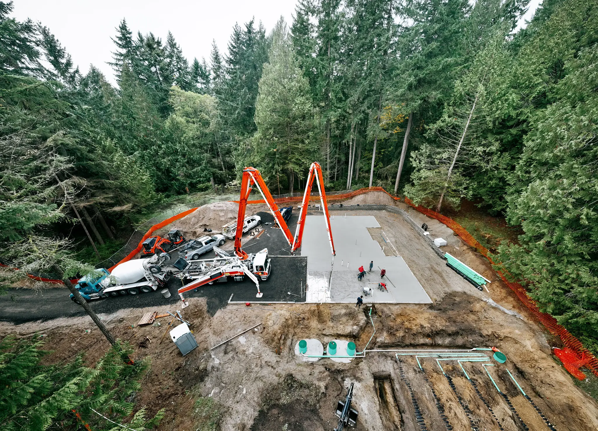 Workers at construction site near trees