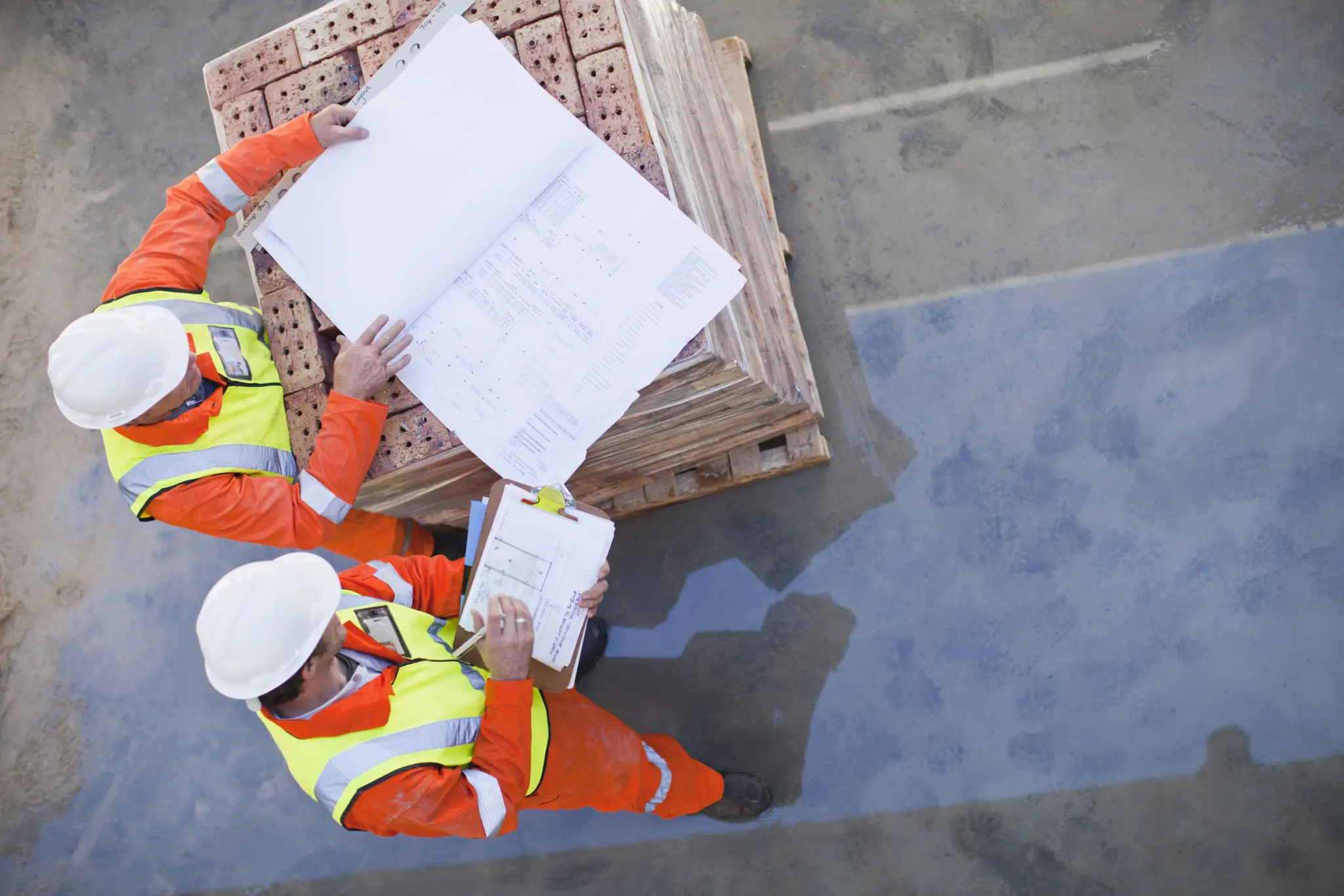 Construction workers reviewing building plans