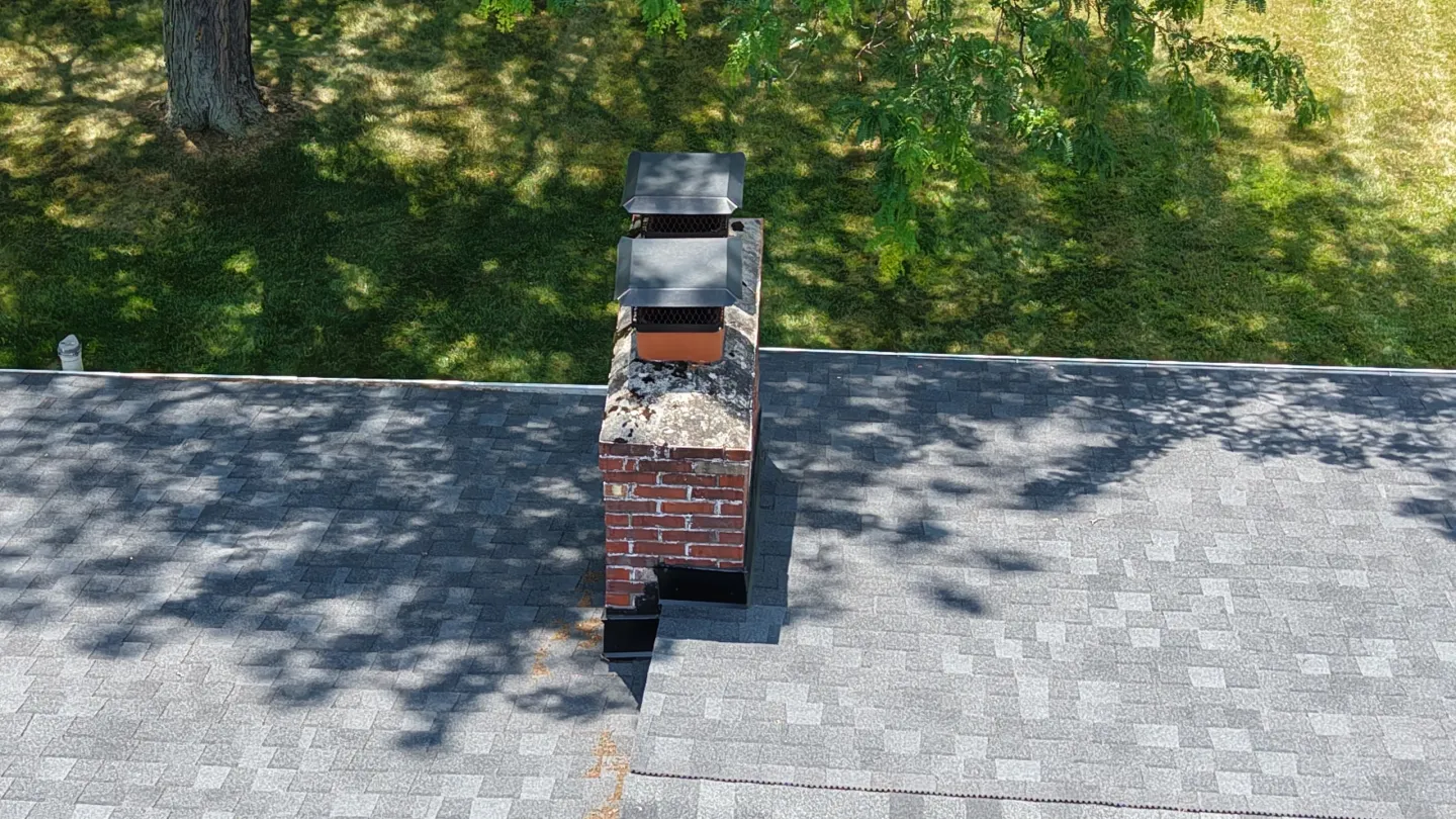 Brick chimney on shingled roof