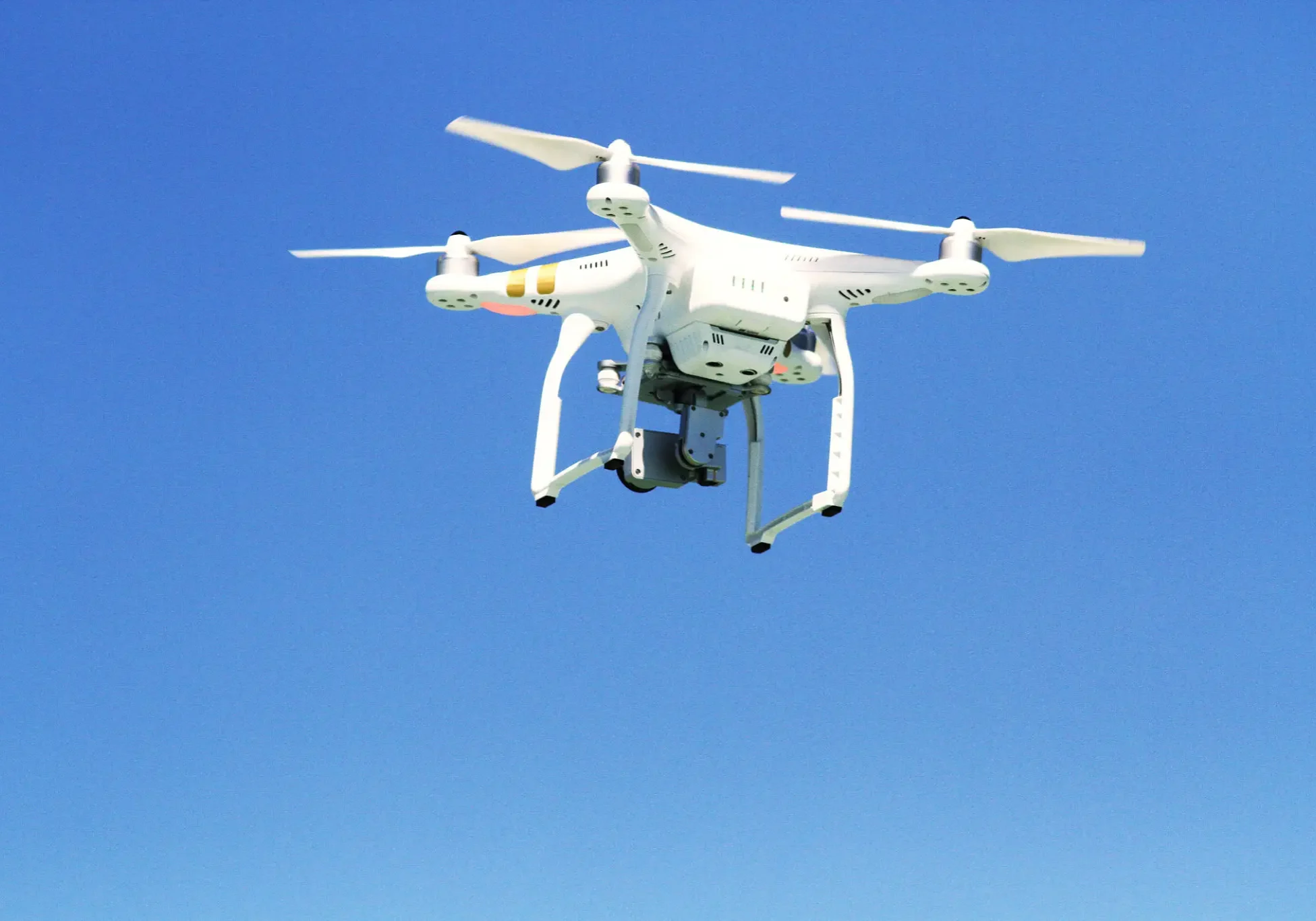 White drone hovering mid-air